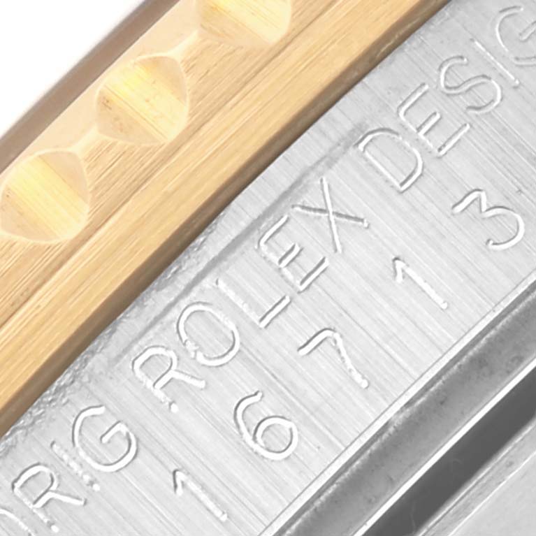 The image shows a close-up of the Rolex GMT-Master 16713 Men
s Steel and Gold (two tone) Brown Dial 16713 Men
s Steel and Gold (two tone) Brown Dial
s side, highlighting the engraved model number and case material details.