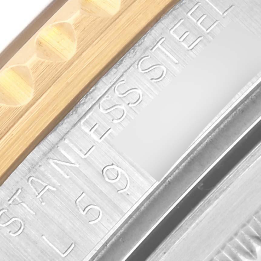 The image shows a detailed angle of the Rolex GMT-Master 16713 Men
s Steel and Gold (two tone) Brown Dial 16713 Men
s Steel and Gold (two tone) Brown Dial watch focusing on the stainless steel engraving on its side.