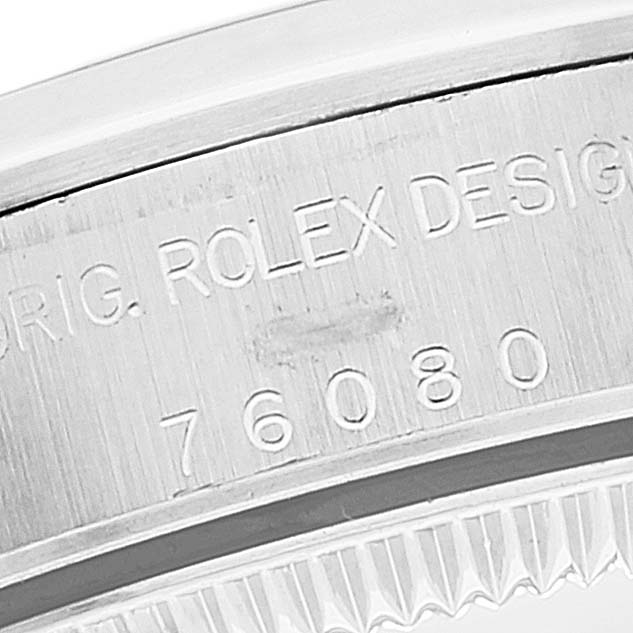 The image shows a close-up of the model number and engravings on the case of a Rolex Oyster Perpetual 76080 Women's Stainless Steel Black Dial 76080 Women's Stainless Steel Black Dial watch.