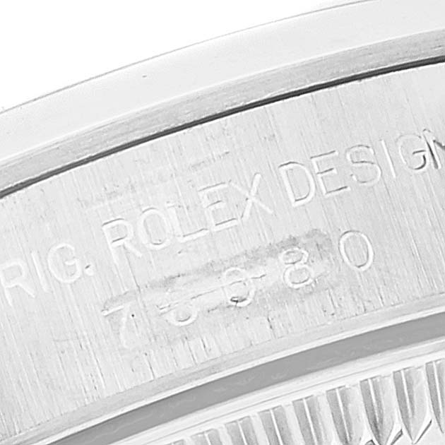 This image shows a close-up of the engraved case back of a Rolex Oyster Perpetual 76080 Women's Stainless Steel Black Dial 76080 Women's Stainless Steel Black Dial watch.