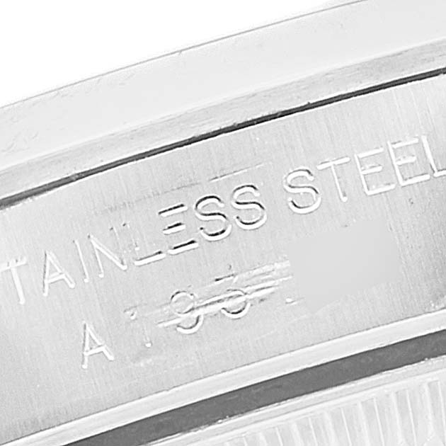 This close-up shows the engraved text on the stainless steel caseback of a Rolex Oyster Perpetual 76080 Women's Stainless Steel Black Dial 76080 Women's Stainless Steel Black Dial watch.