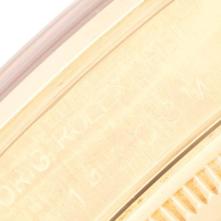 The image shows a close-up of the side engraving on a gold Rolex President 14208M Men
s Yellow Gold Champagne Dial 14208M Men
s Yellow Gold Champagne Dial model watch.