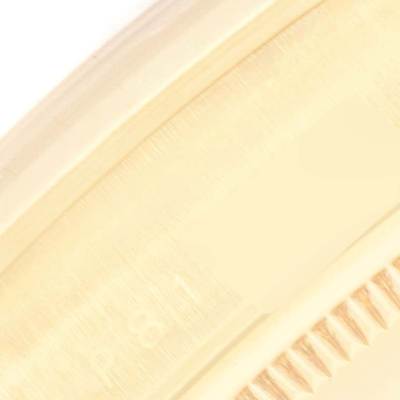 This image shows a close-up partial view of the bezel and case of a Rolex President 14208M Men
s Yellow Gold Champagne Dial 14208M Men
s Yellow Gold Champagne Dial model watch.