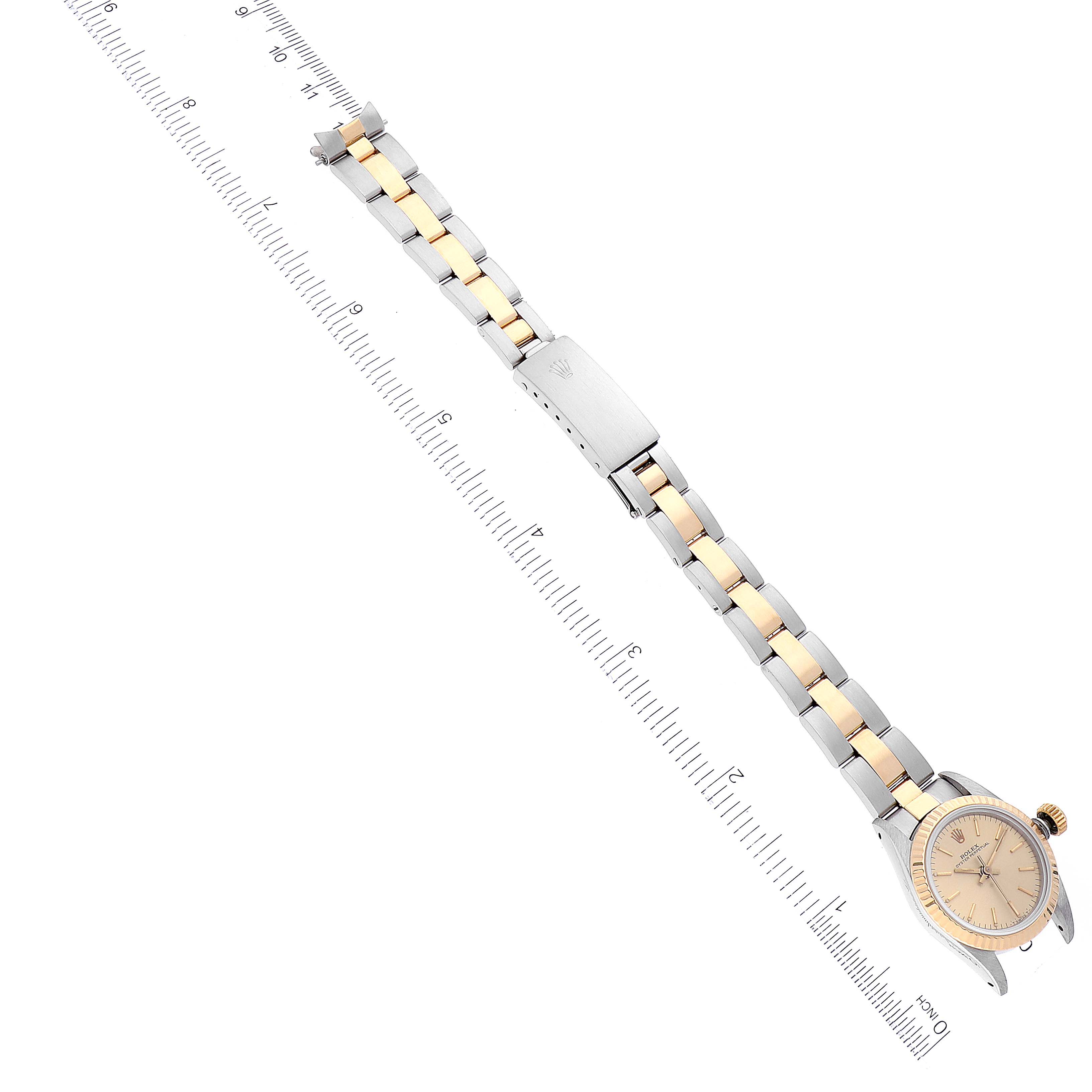 The Rolex Oyster Perpetual 67193 Women
s Steel and Gold (two tone) Champagne Dial 67193 Women
s Steel and Gold (two tone) Champagne Dial watch is shown at an oblique angle highlighting its bracelet, clasp, and part of the dial.