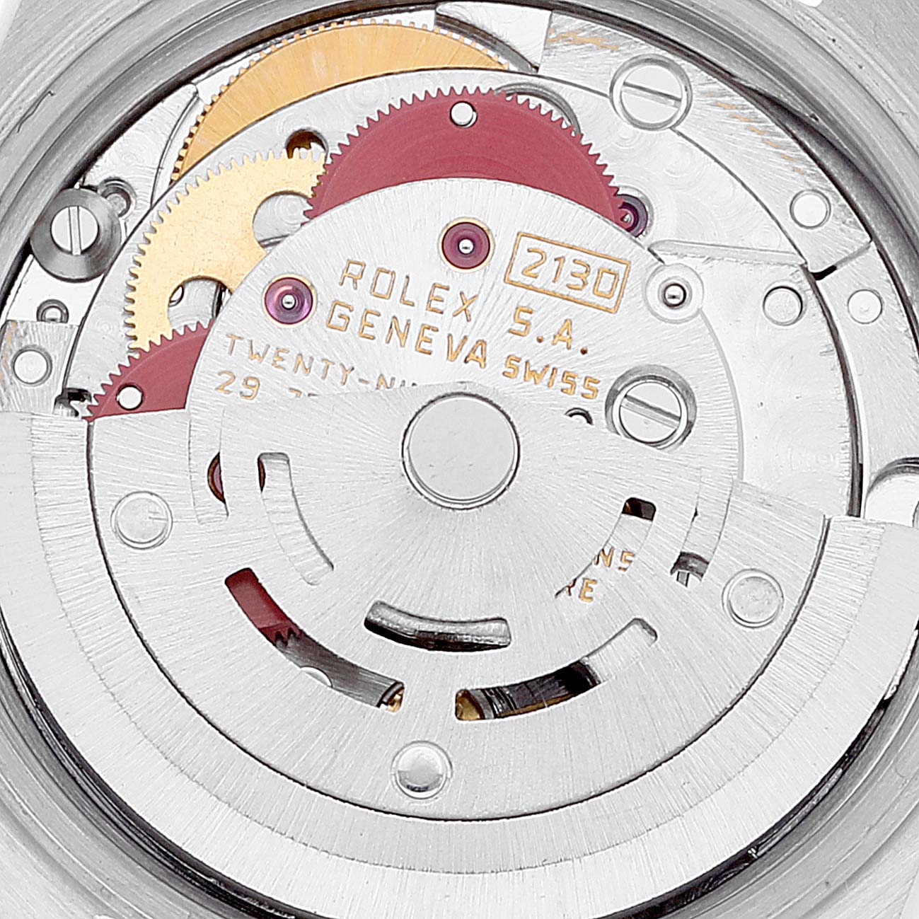 The image shows the internal movement mechanisms of the Rolex Oyster Perpetual 67193 Women
s Steel and Gold (two tone) Champagne Dial 67193 Women
s Steel and Gold (two tone) Champagne Dial watch, including gears and engraved details.