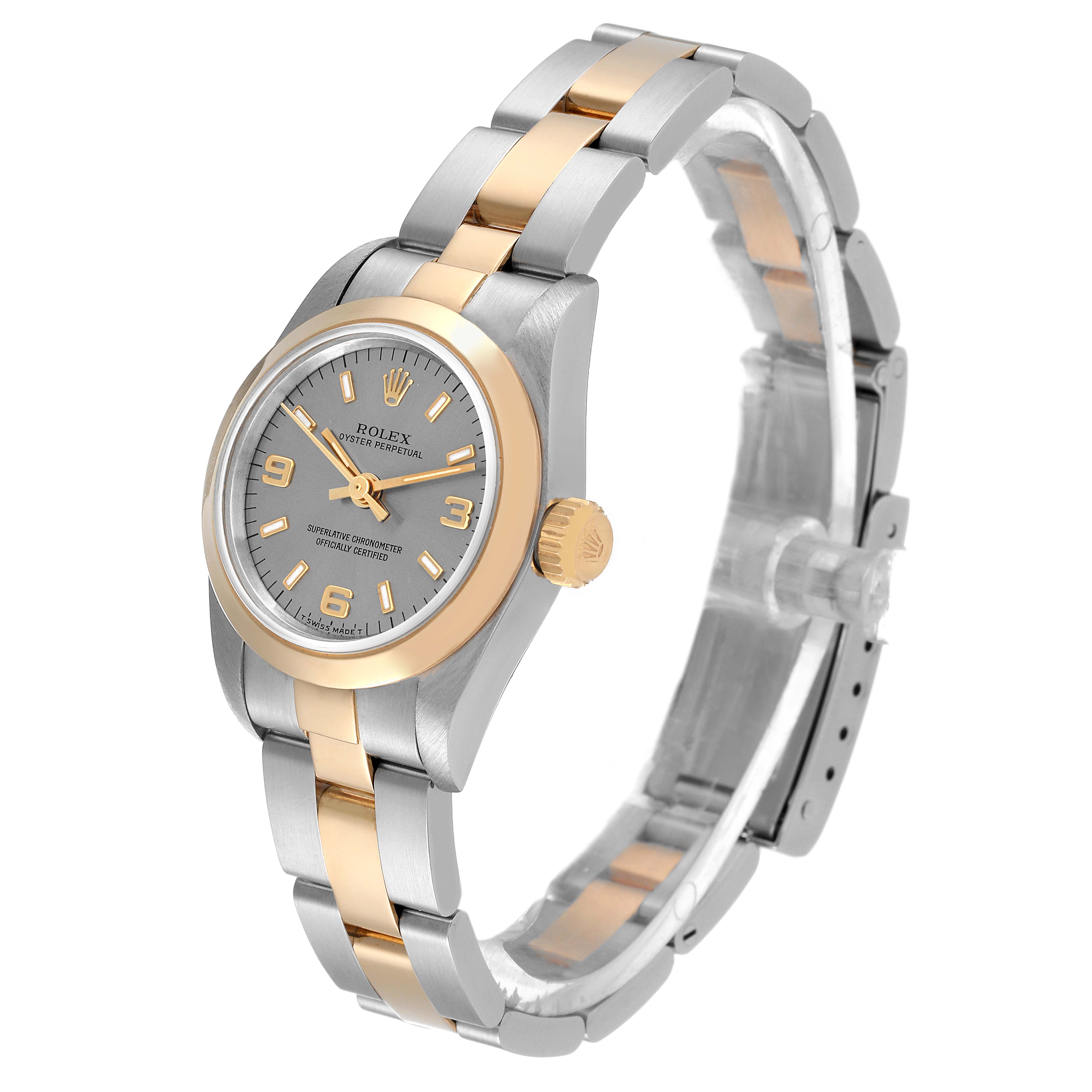 This Rolex Oyster Perpetual 67183 Women
s Steel and Gold (two tone) Silver Dial 67183 Women
s Steel and Gold (two tone) Silver Dial watch is shown from a side angle, highlighting its wristband, face, and crown.