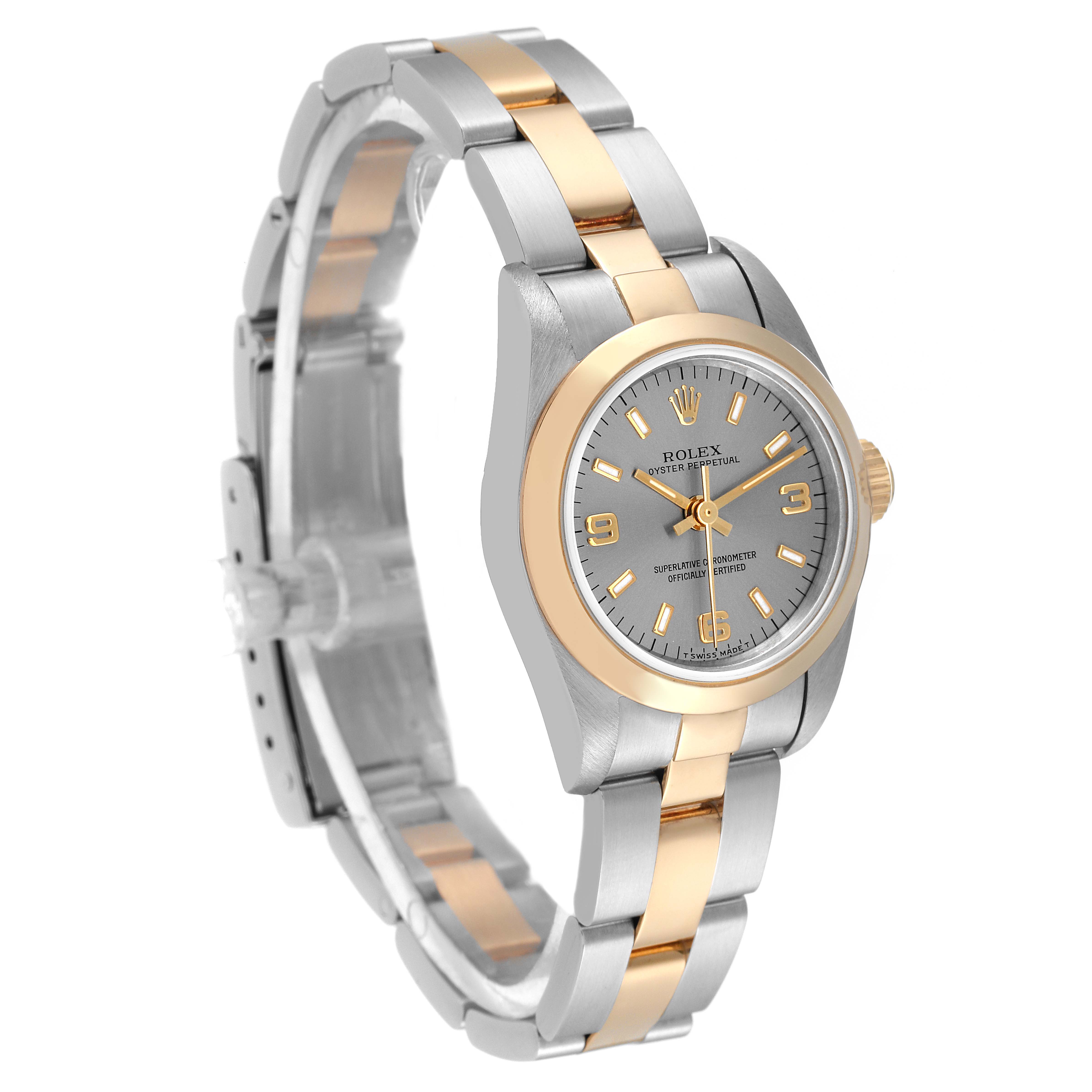 The Rolex Oyster Perpetual 67183 Women
s Steel and Gold (two tone) Silver Dial 67183 Women
s Steel and Gold (two tone) Silver Dial watch is shown at a slight angle, highlighting its two-tone metal band and gray dial face.