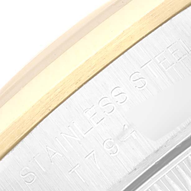 This close-up shows the text engraving on the stainless steel and gold edge of a Rolex Oyster Perpetual 67183 Women
s Steel and Gold (two tone) Silver Dial 67183 Women
s Steel and Gold (two tone) Silver Dial watch.
