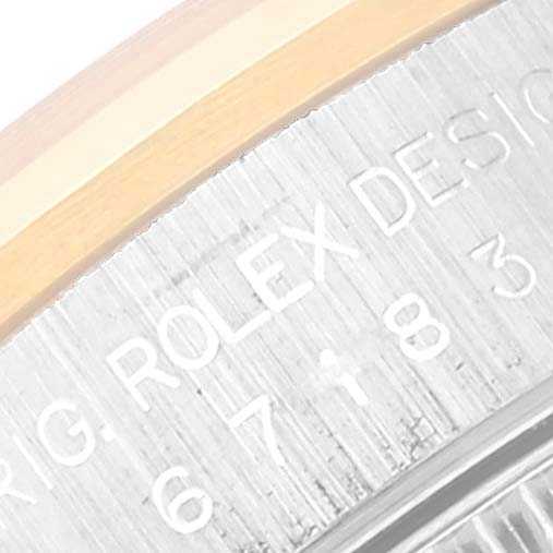 This image shows a close-up of the engraving on the side of a Rolex Oyster Perpetual 67183 Women's Steel and Gold (two tone) Grey Dial 67183 Women's Steel and Gold (two tone) Grey Dial watch case.