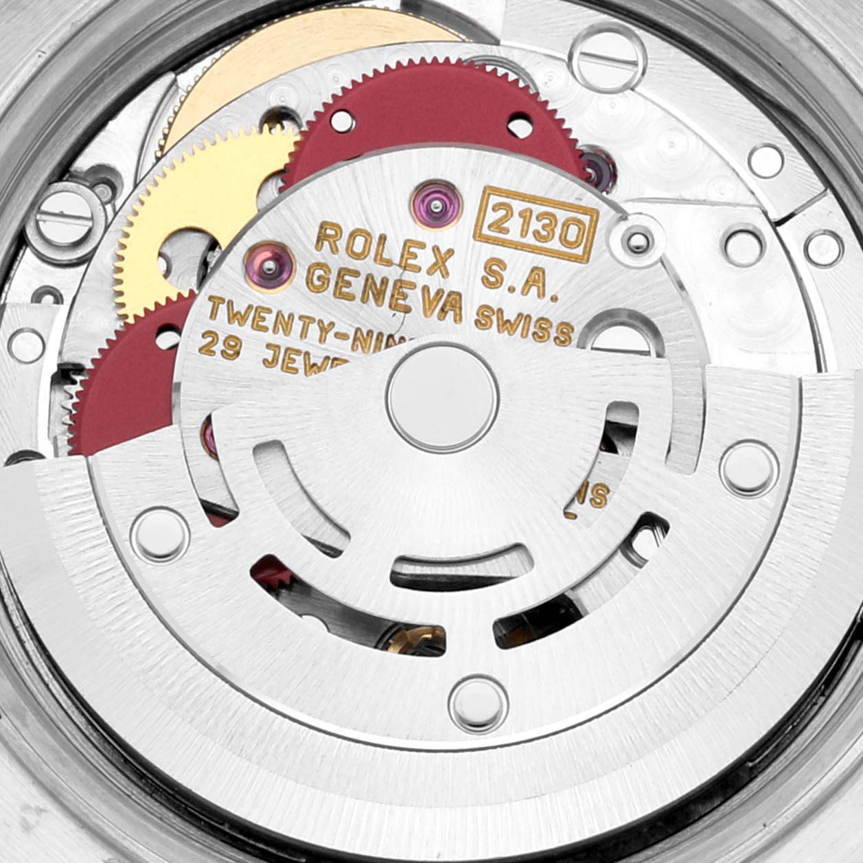 This is a close-up image of the internal mechanism of a Rolex Oyster Perpetual 67183 Women's Steel and Gold (two tone) Grey Dial 67183 Women's Steel and Gold (two tone) Grey Dial watch, showcasing its gears and movement components.