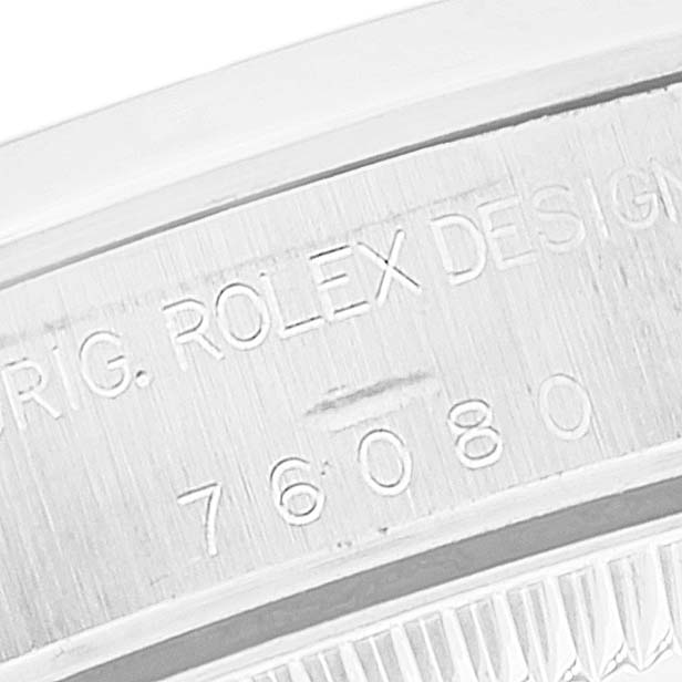 The image shows a close-up of the engraved caseback of a Rolex Oyster Perpetual 76080 Women's Stainless Steel White Dial 76080 Women's Stainless Steel White Dial model, displaying the model number 76080.