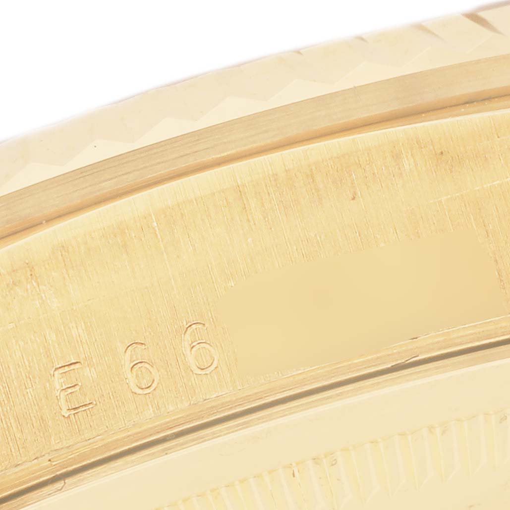 The image shows a detailed close-up of the President model
s gold bezel by Rolex, with engraved markings visible.