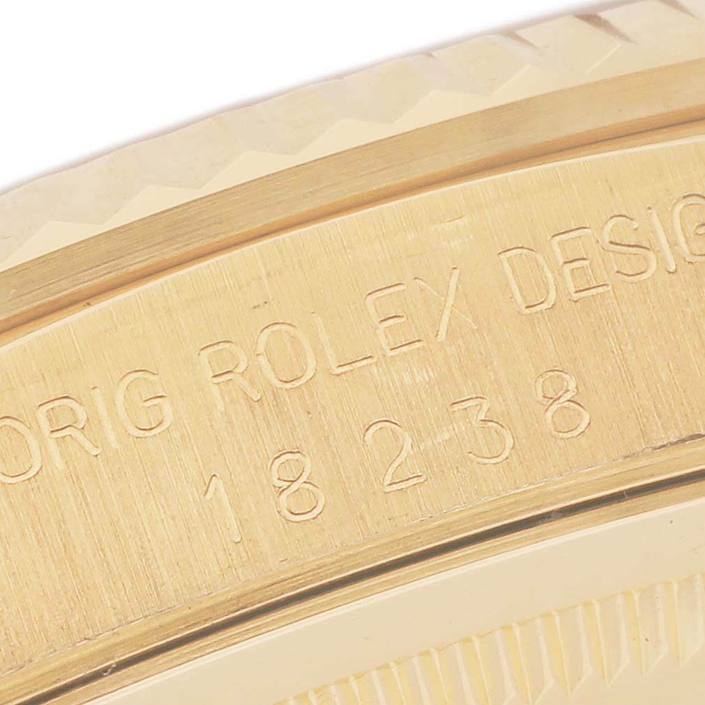 The image shows a close-up of the engraved side of a Rolex President 18238MR Men
s Yellow Gold Champagne Dial 18238MR Men
s Yellow Gold Champagne Dial model watch.