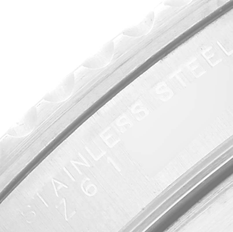 The image shows a close-up of the bezel and case back edge of a Rolex Submariner 14060M Men
s Stainless Steel Black Dial 14060M Men
s Stainless Steel Black Dial, highlighting the "STAINLESS STEEL" engraving.