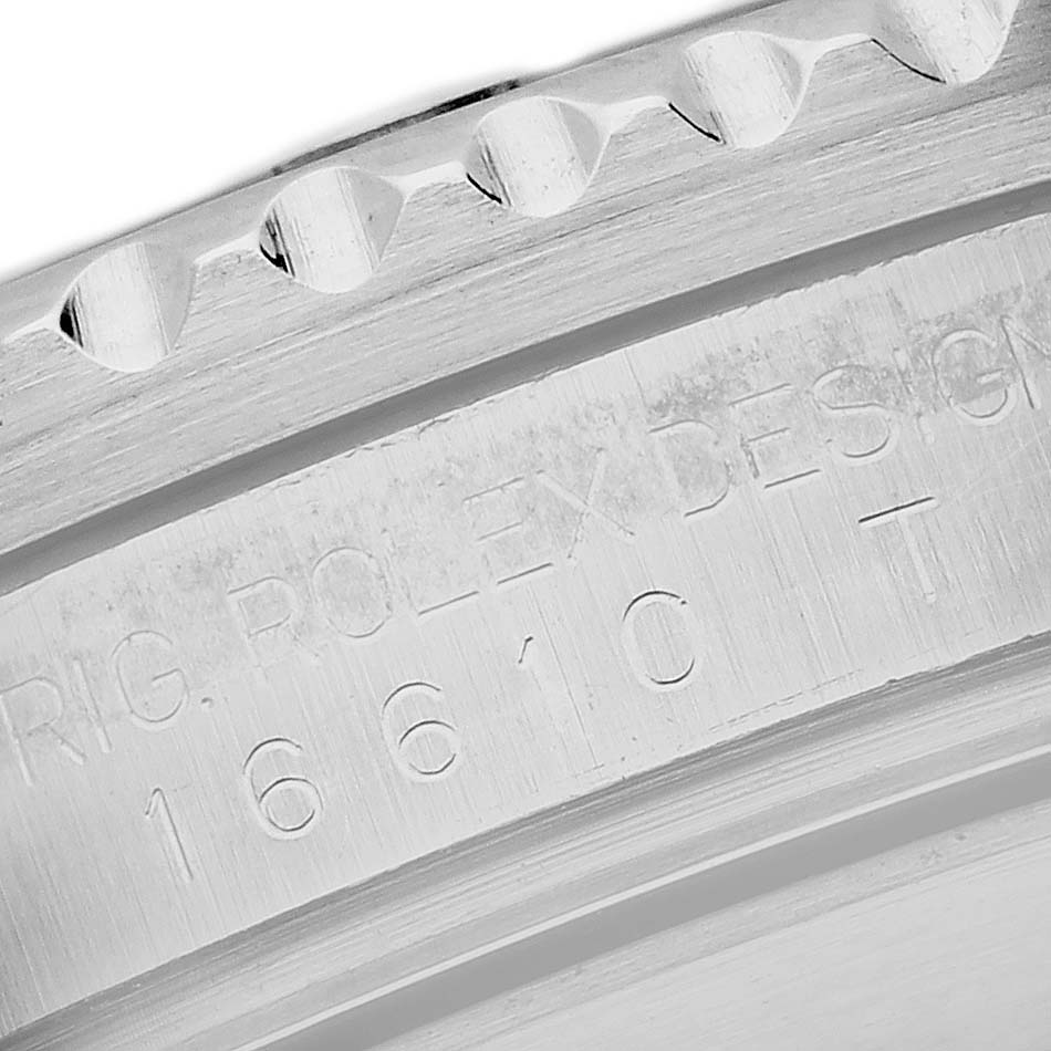 The image shows a close-up of the engraved inner bezel of a Rolex Submariner 16610LV Men's Stainless Steel Black Dial 16610LV Men's Stainless Steel Black Dial watch.