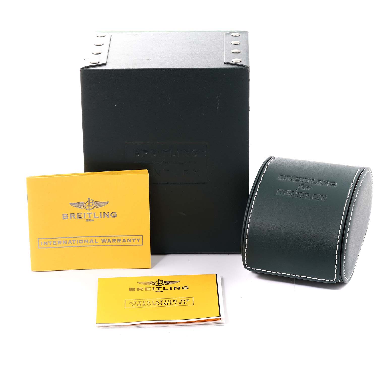 The image shows the packaging, leather pouch, and warranty documents of the Bentley model by Breitling watch.