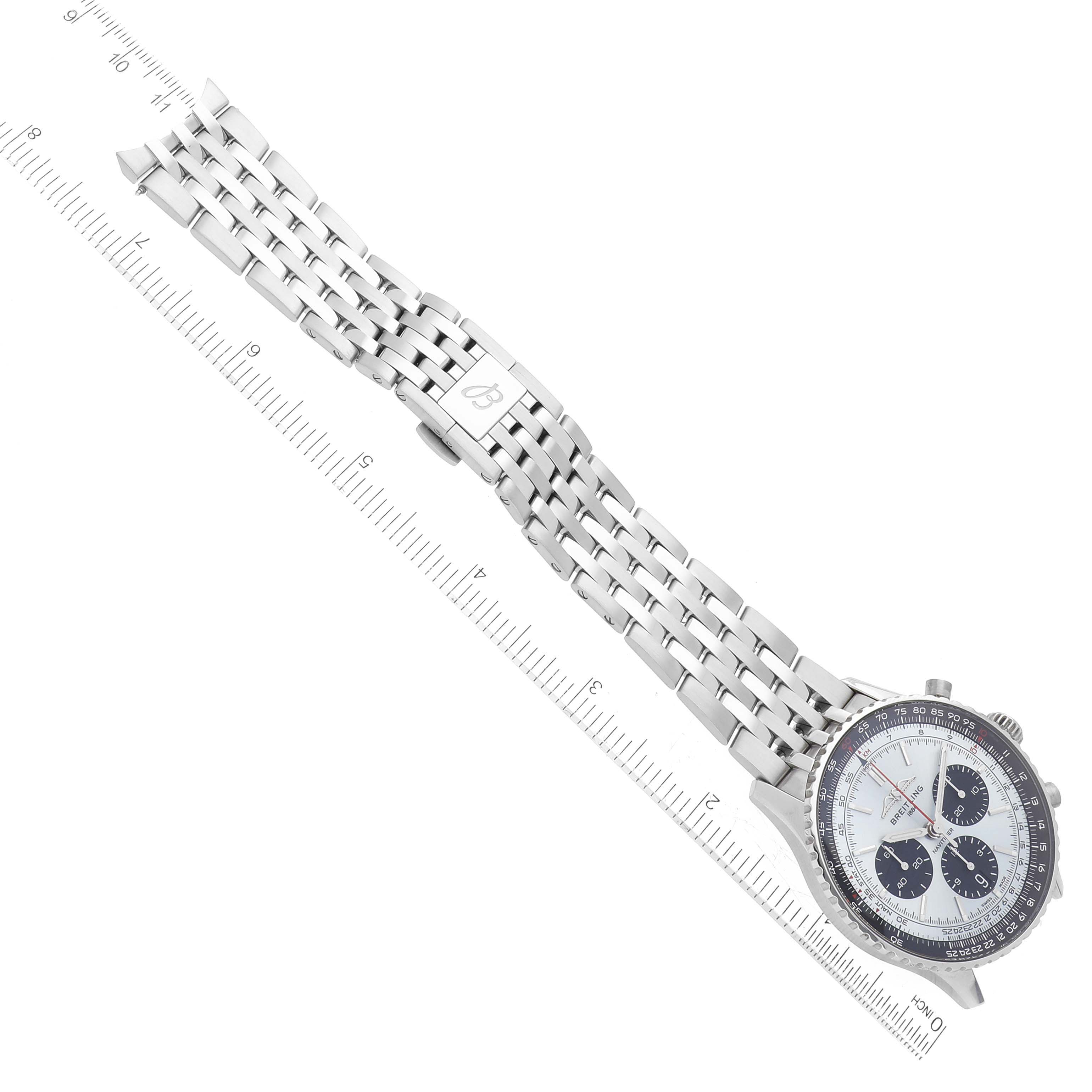 The image shows a Breitling Navitimer AB0138 Men's Stainless Steel Blue Dial AB0138 Men's Stainless Steel Blue Dial watch taken from a top-down angle, featuring its face, bezel, and metal band alongside a measurement ruler.