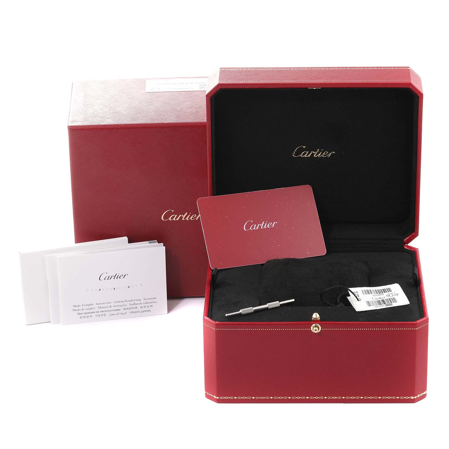 The image shows a Cartier Santos WSSA0030 Men's Stainless Steel Blue Dial WSSA0030 Men's Stainless Steel Blue Dial watch box with inside components like paperwork, a warranty card, and a tool.