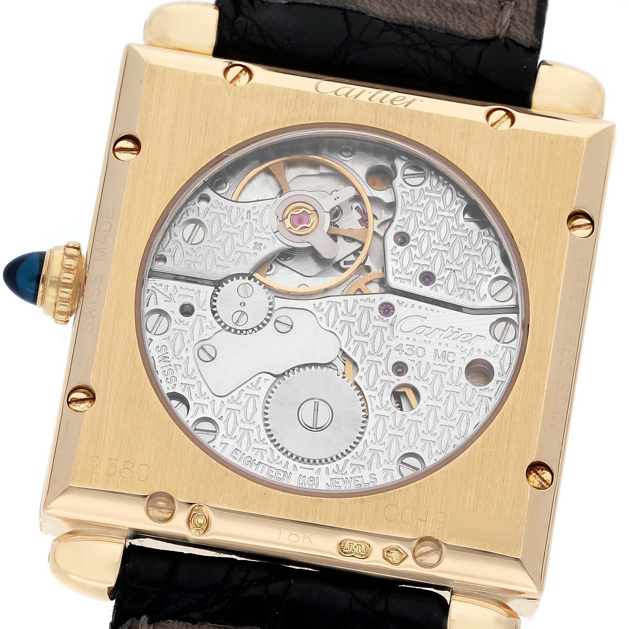 The image shows the back view of the Cartier Tank Obus W1527551 Men's Yellow Gold Silver Dial W1527551 Men's Yellow Gold Silver Dial watch, displaying its mechanical movement and internal components.