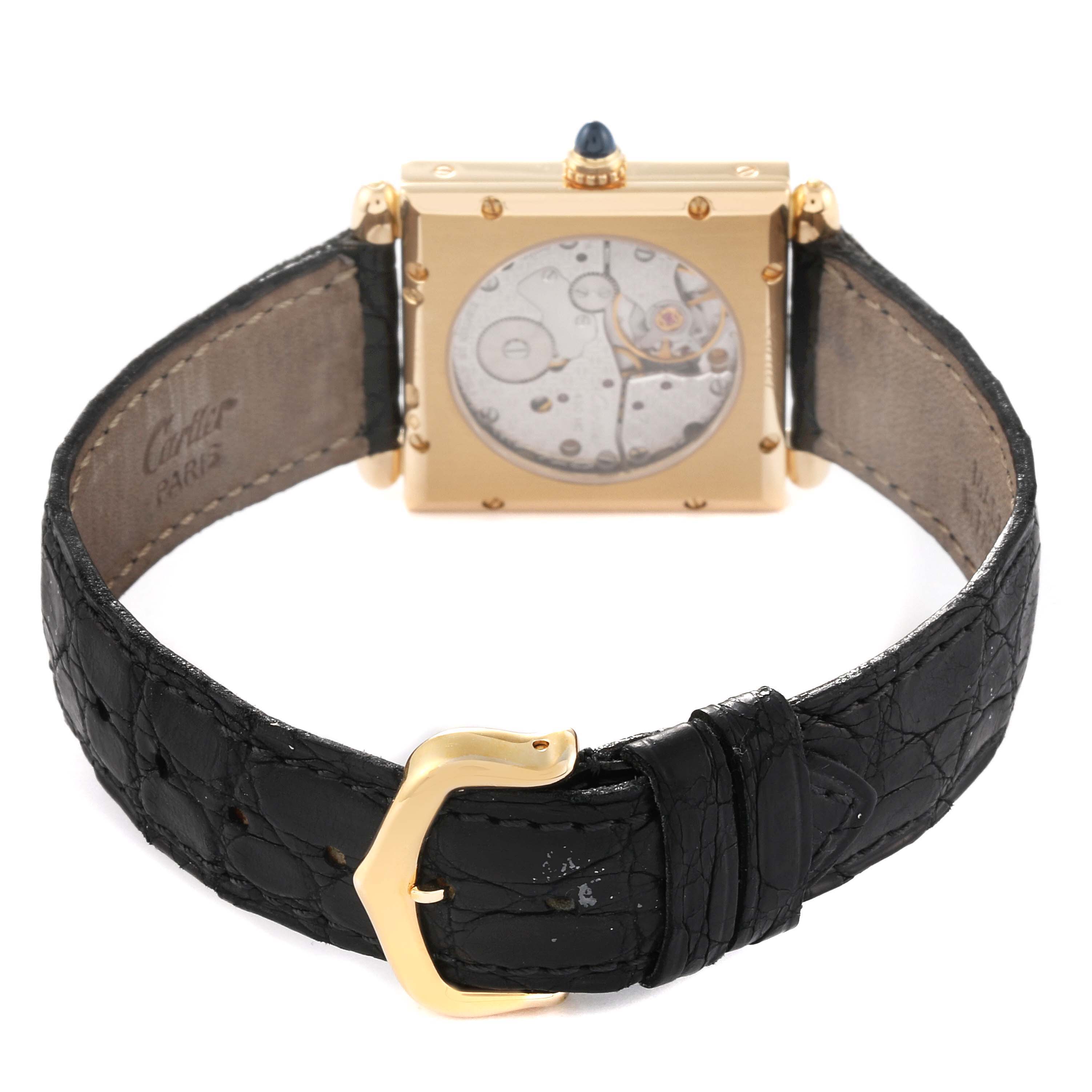 The image shows the back view of a Cartier Tank Obus W1527551 Men's Yellow Gold Silver Dial W1527551 Men's Yellow Gold Silver Dial watch, highlighting the movement and leather strap with a gold buckle.