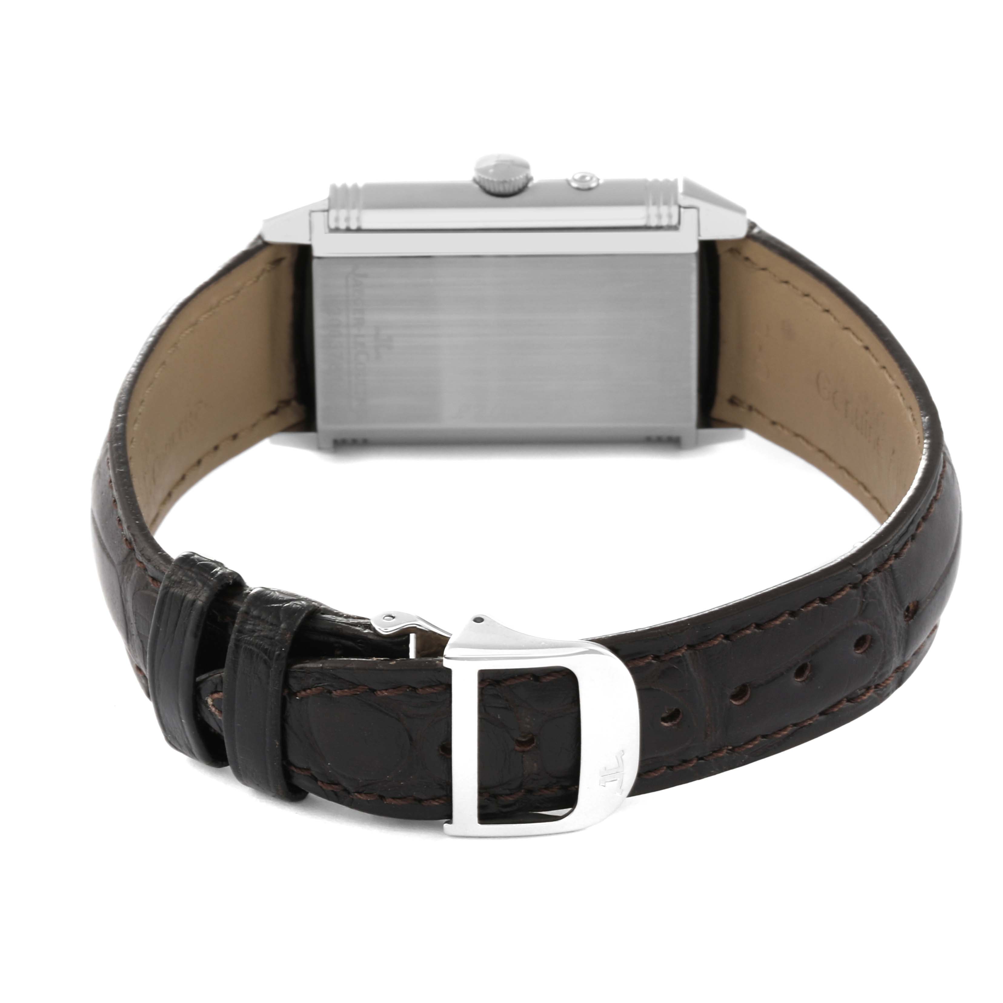 The image shows the back view of a Jaeger-LeCoultre Reverso watch, highlighting the rectangular case and leather strap with a clasp.