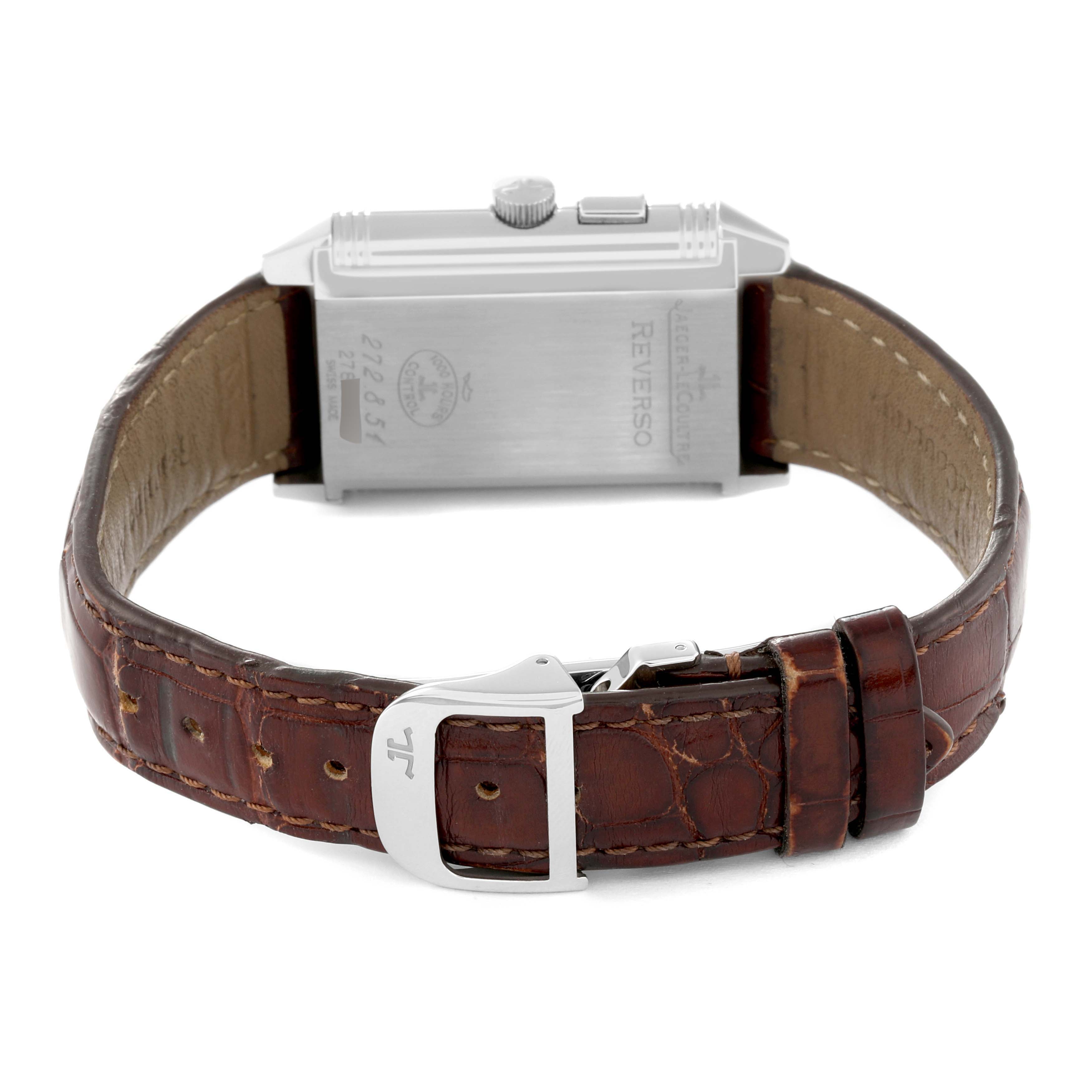 The image shows the back view of a Jaeger-LeCoultre Reverso watch, including the case back, crown, strap, and buckle.
