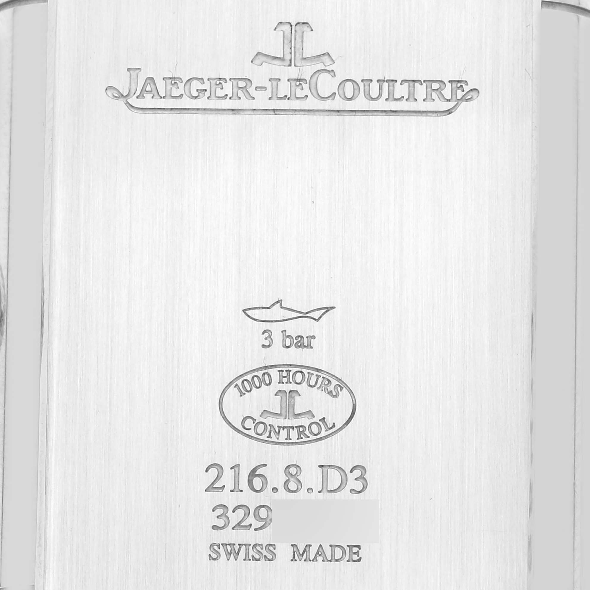 This image shows the engraved back of a Jaeger-LeCoultre Reverso watch, detailing its water resistance and model information.