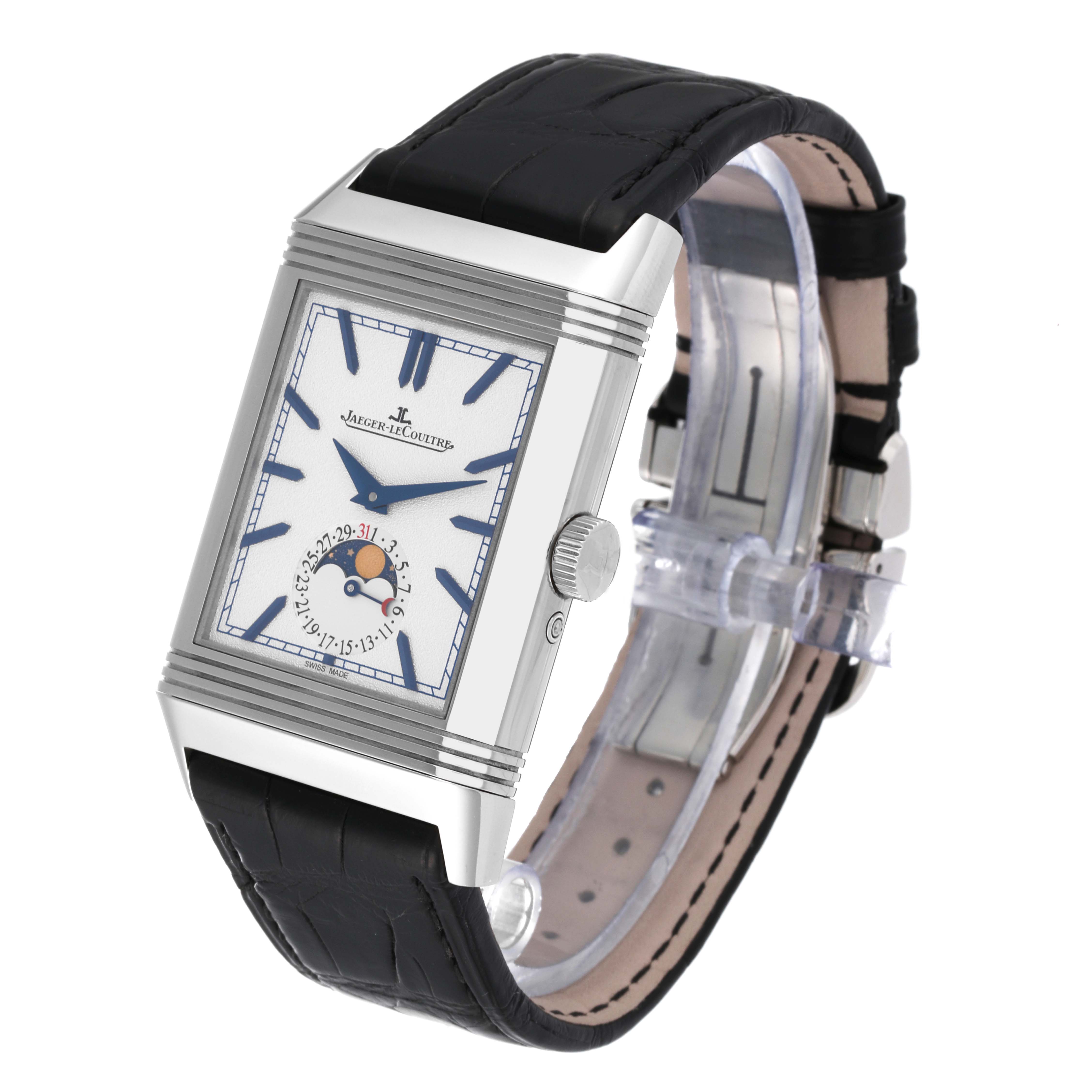 The Jaeger-LeCoultre Reverso watch is shown at a three-quarter angle, highlighting its rectangular dial, moon phase feature, and black leather strap.