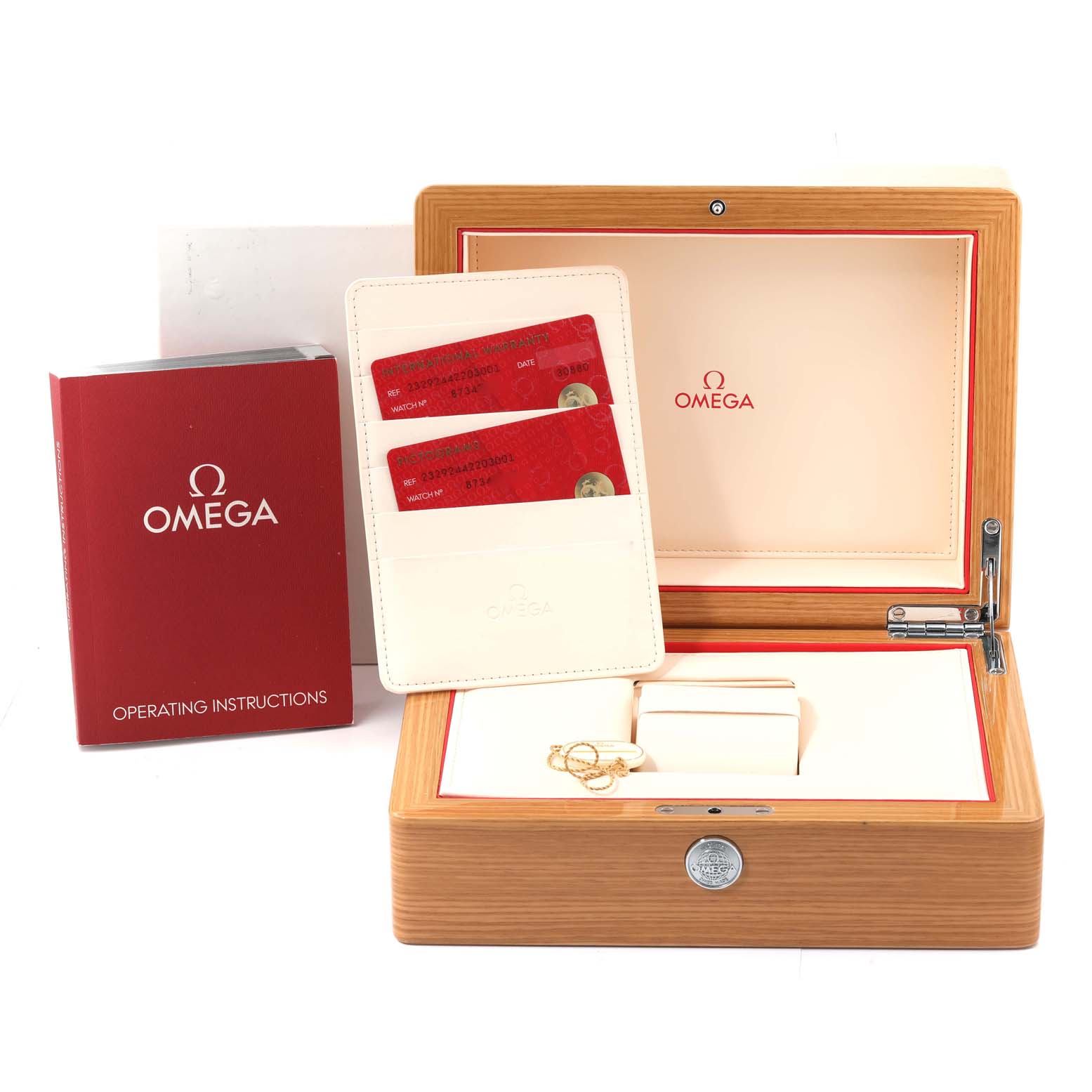 The image shows the box and accessories for the Omega Planet Ocean 232.92.44.22.03.001 Men
s Titanium Blue Dial 232.92.44.22.03.001 Men
s Titanium Blue Dial model, including operating instructions and warranty cards.