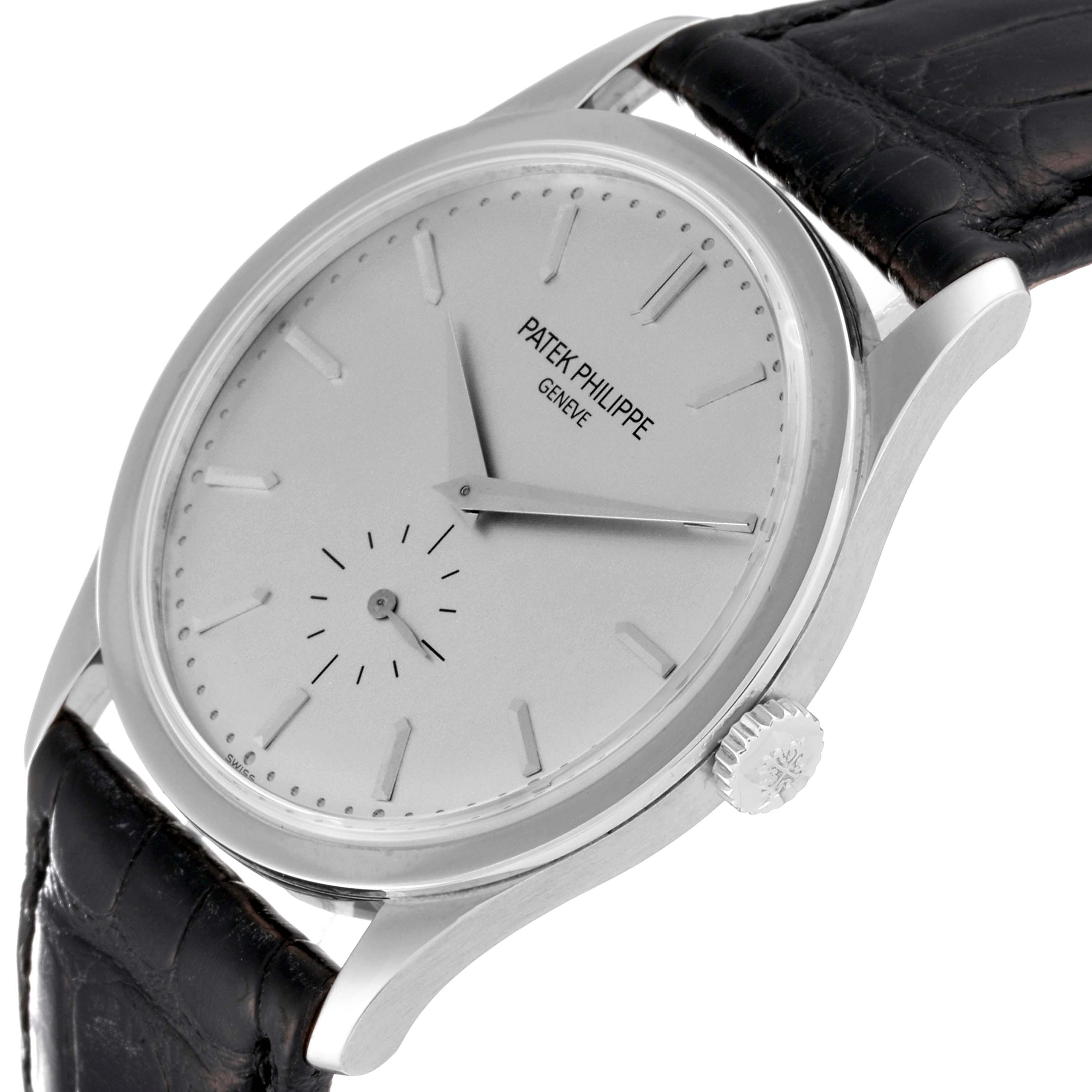 The image shows a slight side angle of a Patek Philippe Calatrava 5196G Men
s White Gold Silver Dial 5196G Men
s White Gold Silver Dial watch, highlighting its crown, dial, and leather strap.
