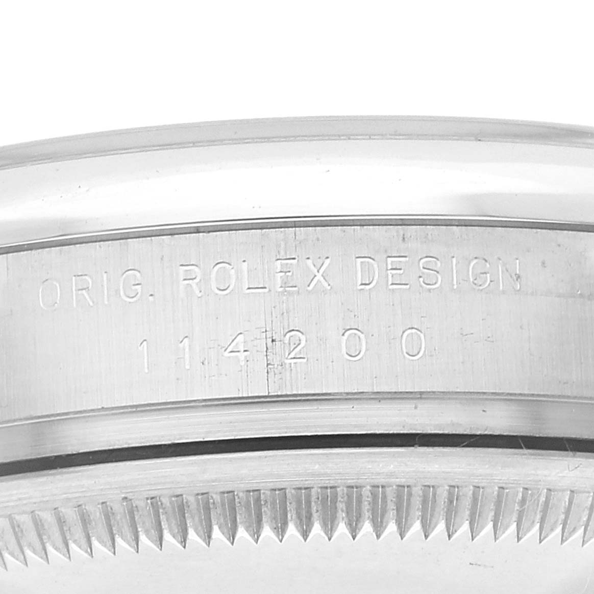 This image shows a close-up of the side engraving on a Rolex Air-King 114200 Men's Stainless Steel White Dial 114200 Men's Stainless Steel White Dial, displaying "ORIG. ROLEX DESIGN 114200."