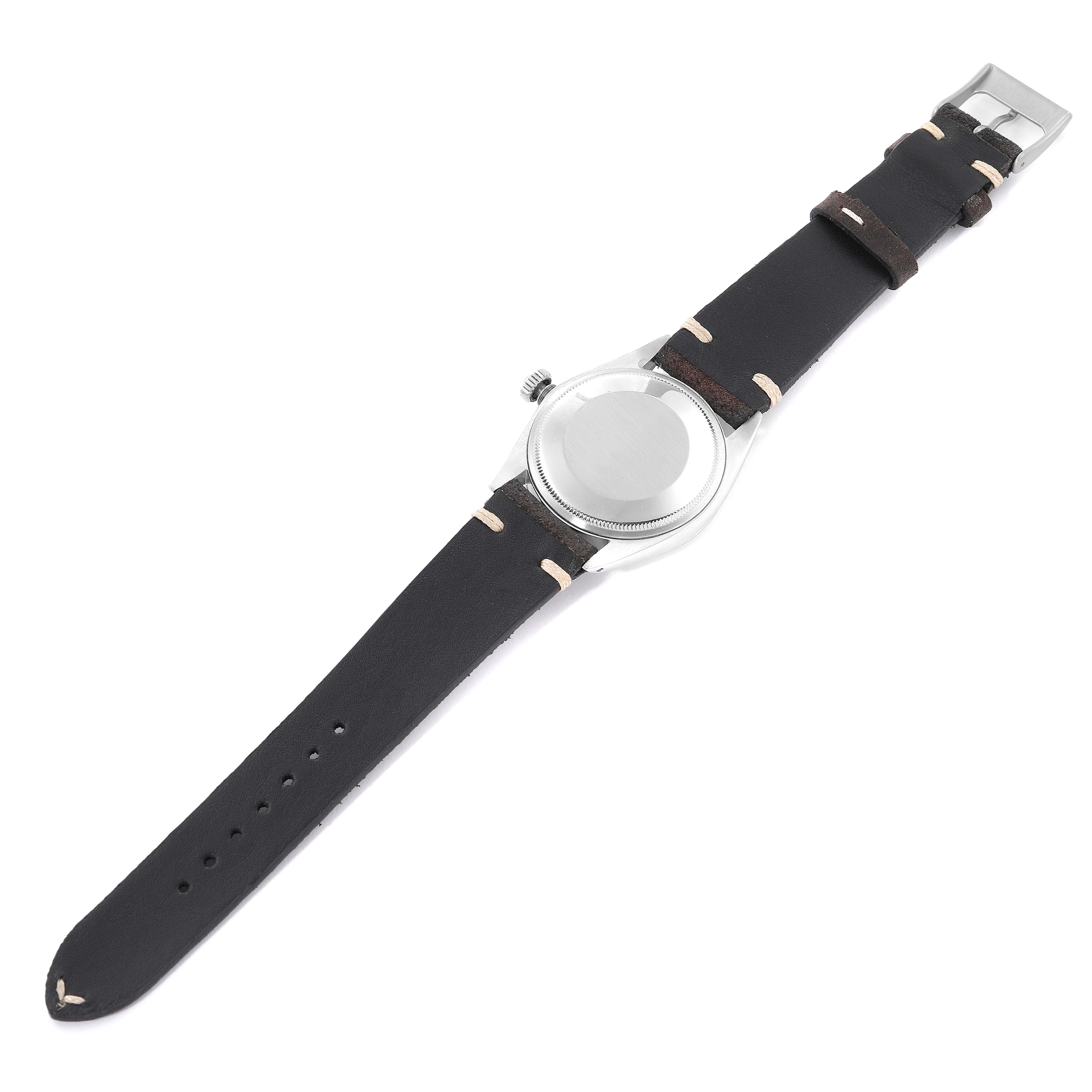 The image shows the back view of a Rolex Date 1500 Men
s Stainless Steel Silver Dial 1500 Men
s Stainless Steel Silver Dial model watch with a leather strap and stainless steel caseback.