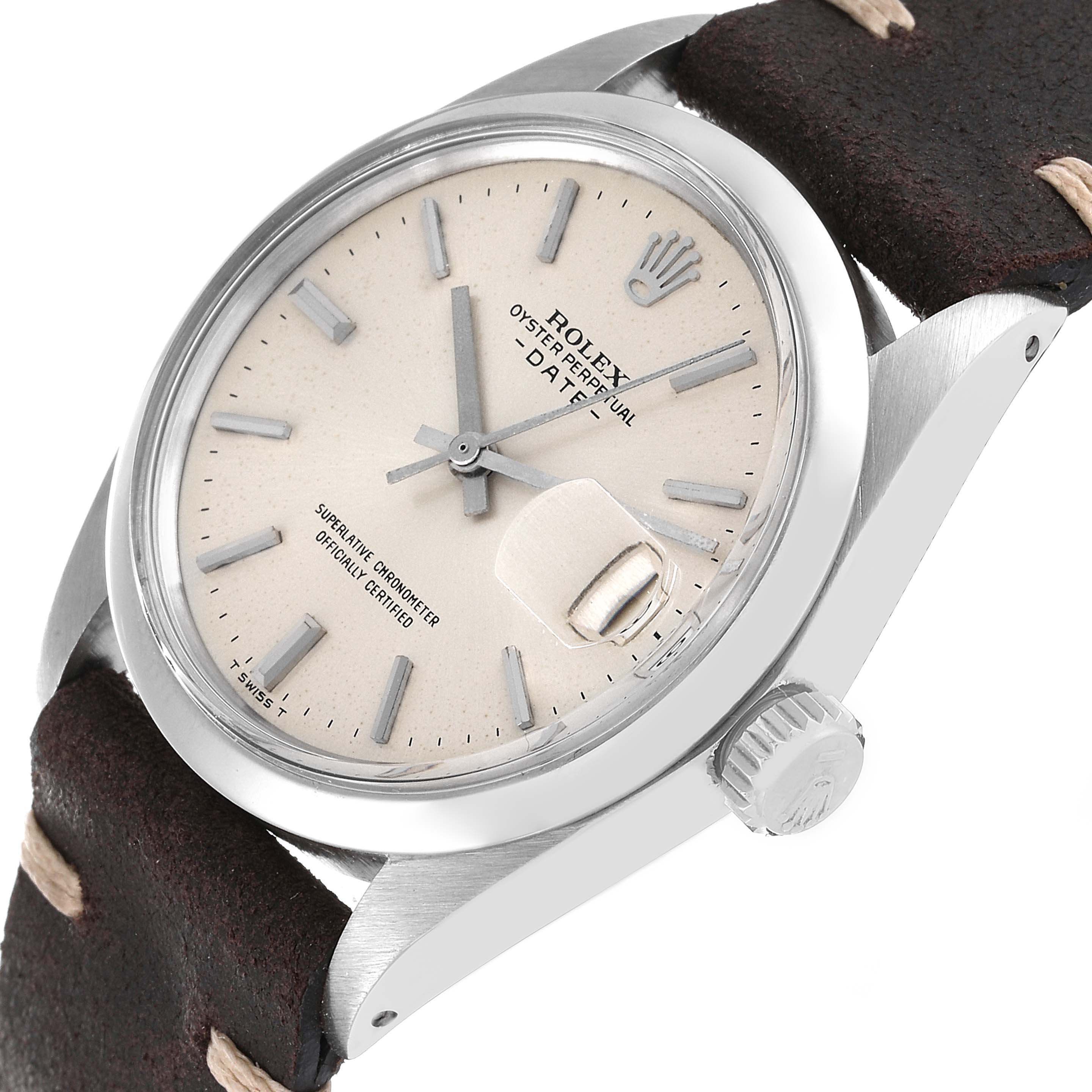 The image shows a close-up of a Rolex Date 1500 Men
s Stainless Steel Silver Dial 1500 Men
s Stainless Steel Silver Dial model watch, highlighting the dial, crown, and part of the leather strap.