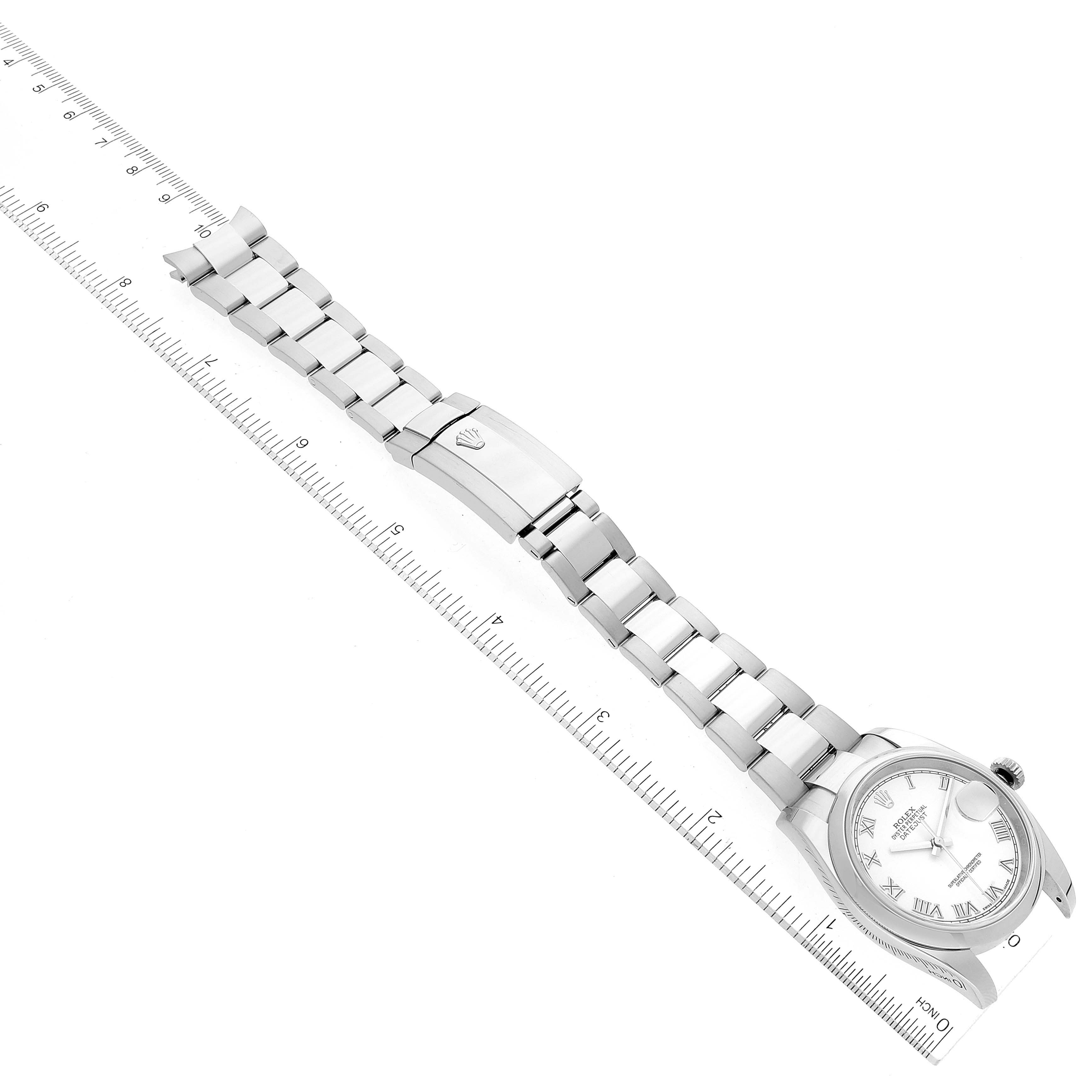 The Rolex Datejust 116200 Men's Stainless Steel White Dial 116200 Men's Stainless Steel White Dial watch is shown flat, with the watch face, bracelet, and clasp visible, alongside a measuring ruler.