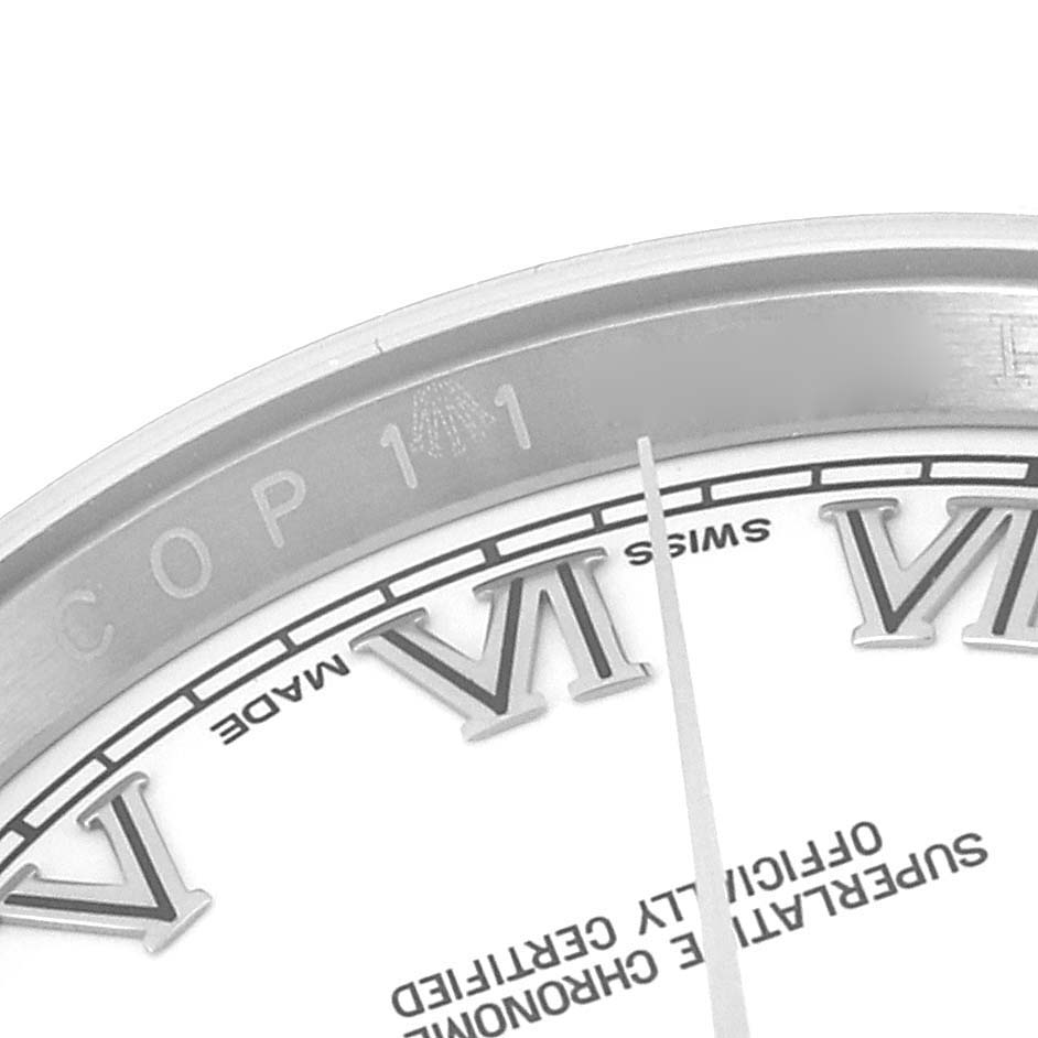 This close-up image displays the dial and part of the bezel of a Rolex Datejust 116200 Men's Stainless Steel White Dial 116200 Men's Stainless Steel White Dial watch, highlighting Roman numerals and some text.