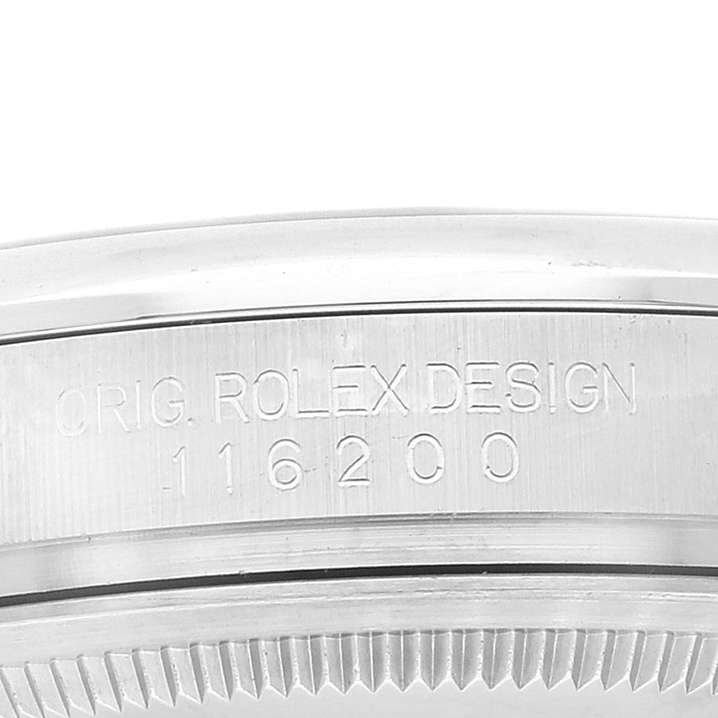 This image shows a close-up of the engraved bezel edge for a Rolex Datejust 116200 Men's Stainless Steel White Dial 116200 Men's Stainless Steel White Dial model.