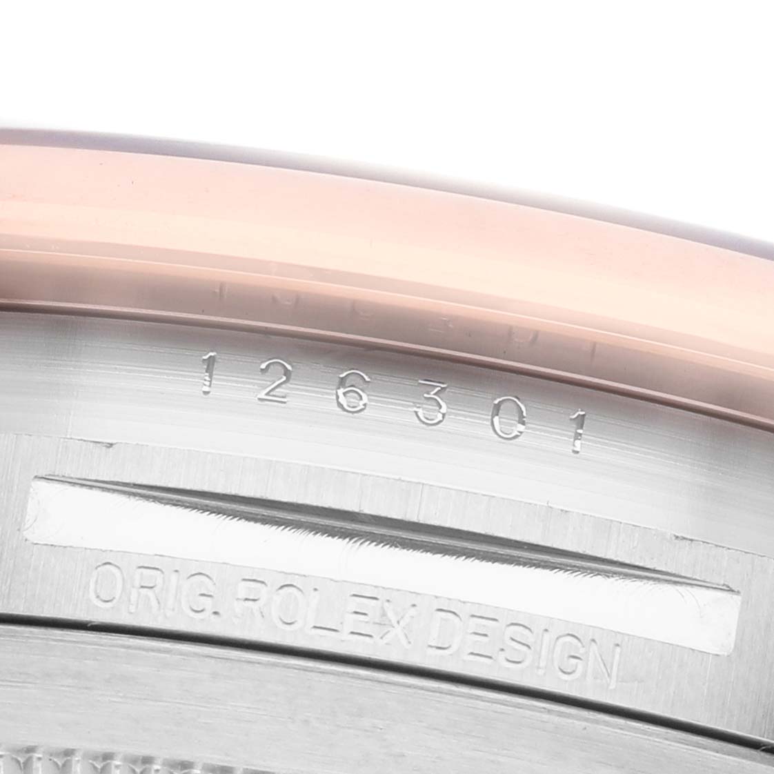 The image shows a close-up of the bezel and engraved serial number of a Rolex Datejust 41 126301 Men's Steel and Gold (two tone) Grey Dial.