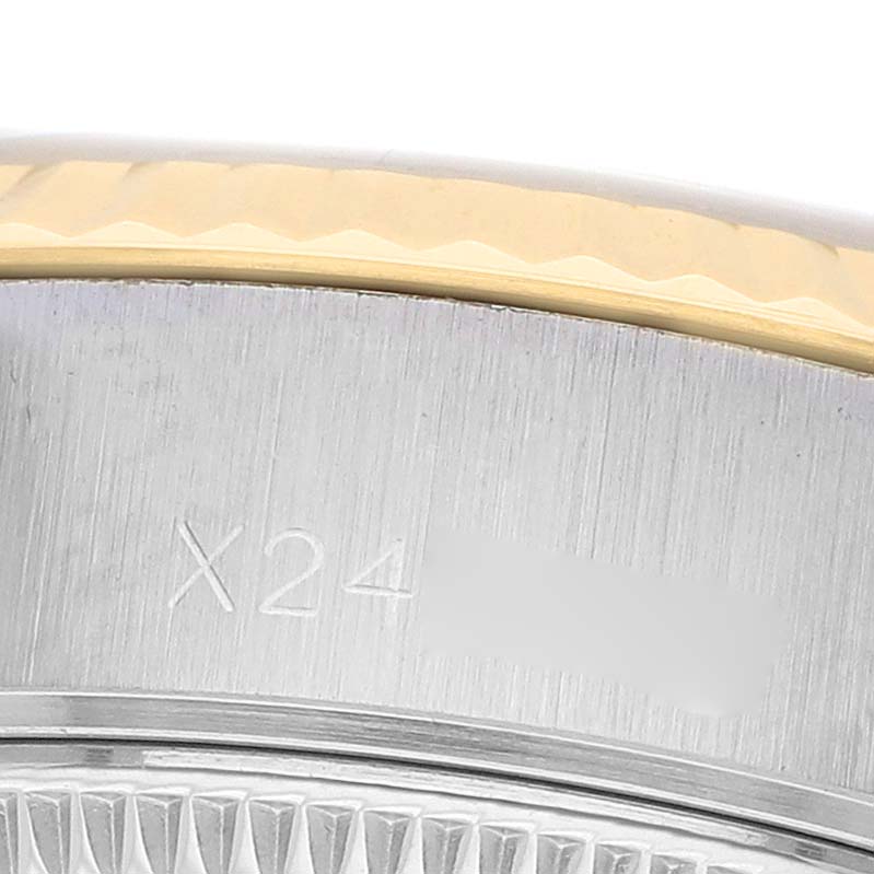 The image shows a close-up of the Rolex Datejust 69173 Women's Steel and Gold (two tone) Champagne Dial's case edge, highlighting the fluted bezel and engraved serial number.