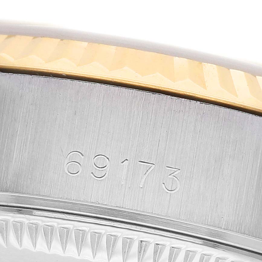 The image shows a side view of a Rolex Datejust 69173 Women's Steel and Gold (two tone) Champagne Dial watch, highlighting the serial number, stainless steel case, and gold fluted bezel.