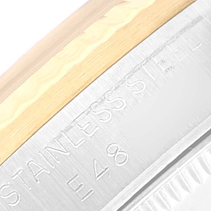 This close-up image of a Rolex Mid-Size 68273 Women
s Steel and Gold (two tone) Black Dial 68273 Women
s Steel and Gold (two tone) Black Dial watch shows part of the stainless steel case and bezel.