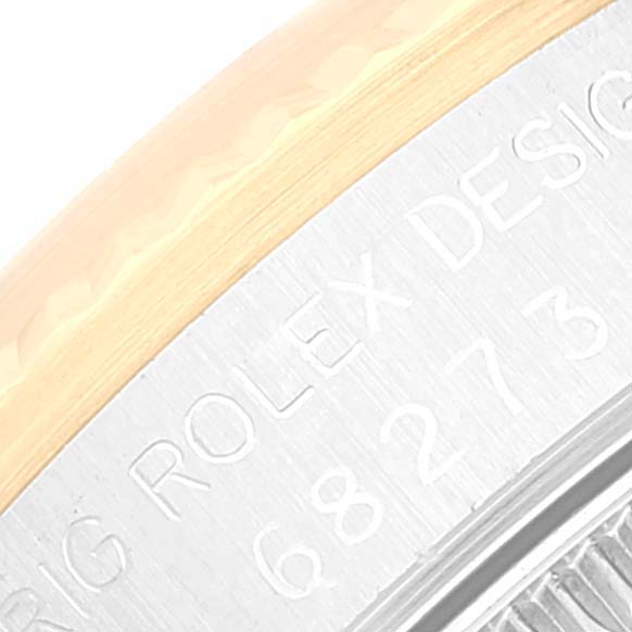 The image shows a close-up of the case back edge on a Mid-Size Rolex watch, showcasing the brand engraving and part of the serial number.