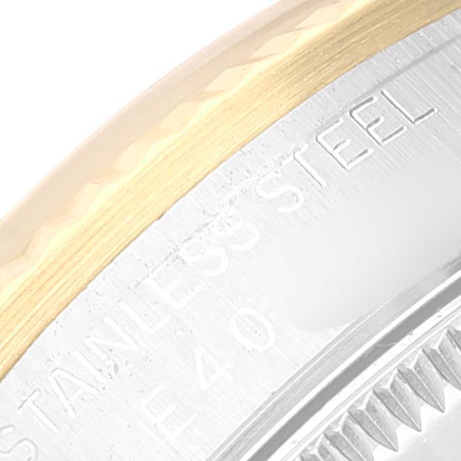 This image shows a close-up view of the bezel and part of the case and engraving on a Mid-Size Rolex watch.