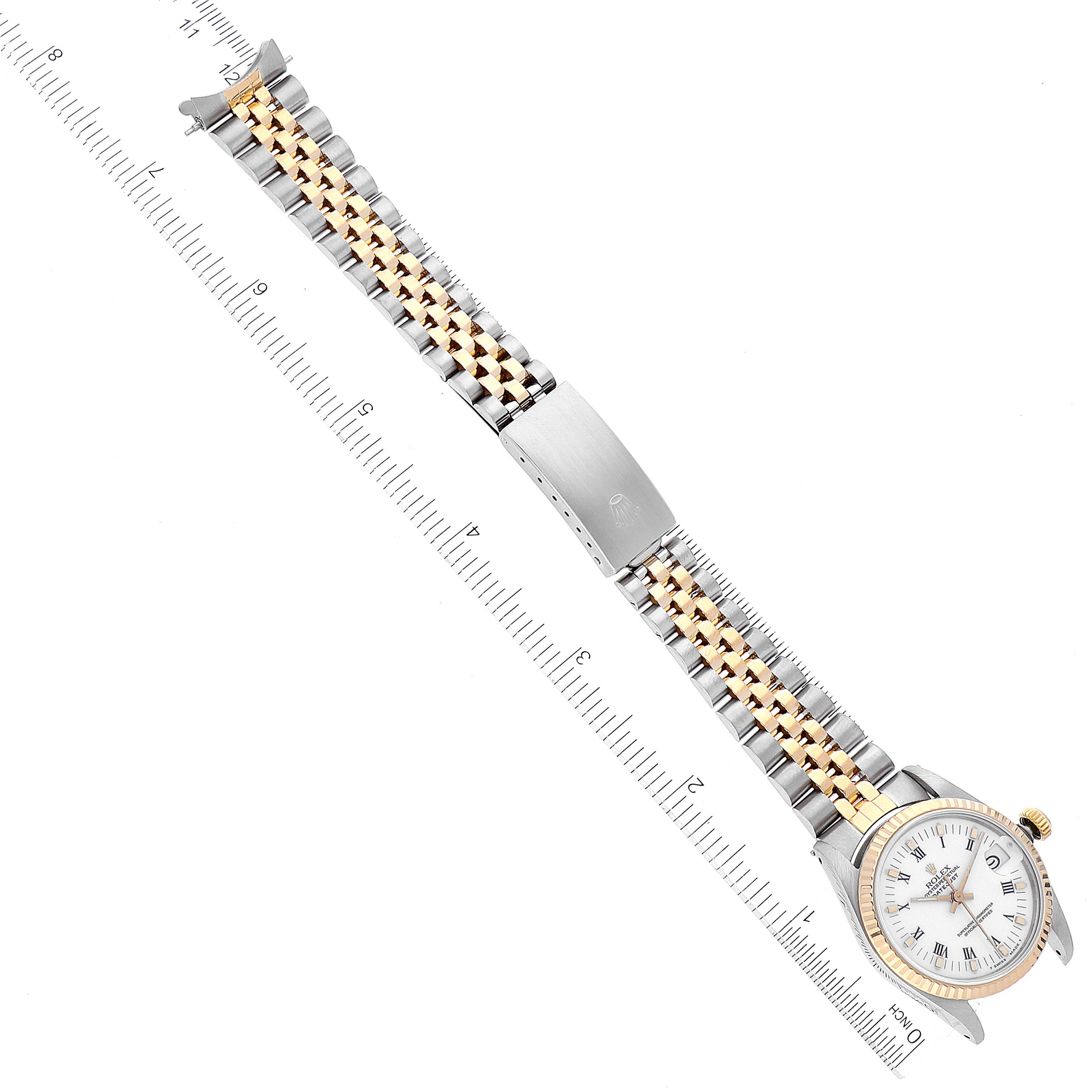 The image shows a Rolex Mid-Size 68273 Women
s Steel and Gold (two tone) White Dial 68273 Women
s Steel and Gold (two tone) White Dial watch photographed from above, displaying the full bracelet, dial, and clasp against a ruler for scale.