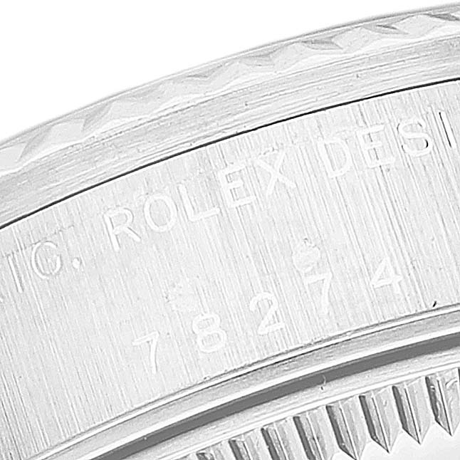 The image shows a close-up angle of the casing, specifically the engraved serial and model number, on a Rolex Mid-Size 78274 Women
s Stainless Steel Silver Dial 78274 Women
s Stainless Steel Silver Dial watch.