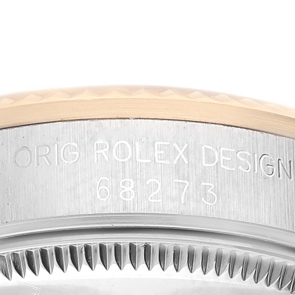 This image shows a close-up of the case side and bezel with engraved text of a Mid-Size Rolex model 68273.