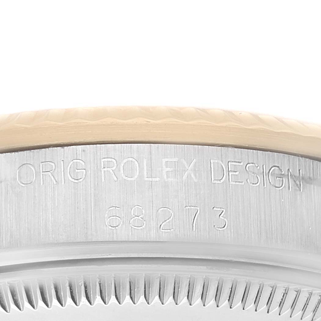 The image shows a close-up of the serial number engraving on the side of a Mid-Size Rolex watch case.