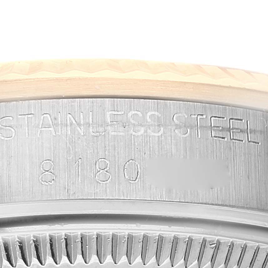 This image shows a close-up of the case engraving on a Rolex Mid-Size 68273 Women
s Steel and Gold (two tone) Champagne Dial 68273 Women
s Steel and Gold (two tone) Champagne Dial watch, highlighting its serial number and stainless steel material.