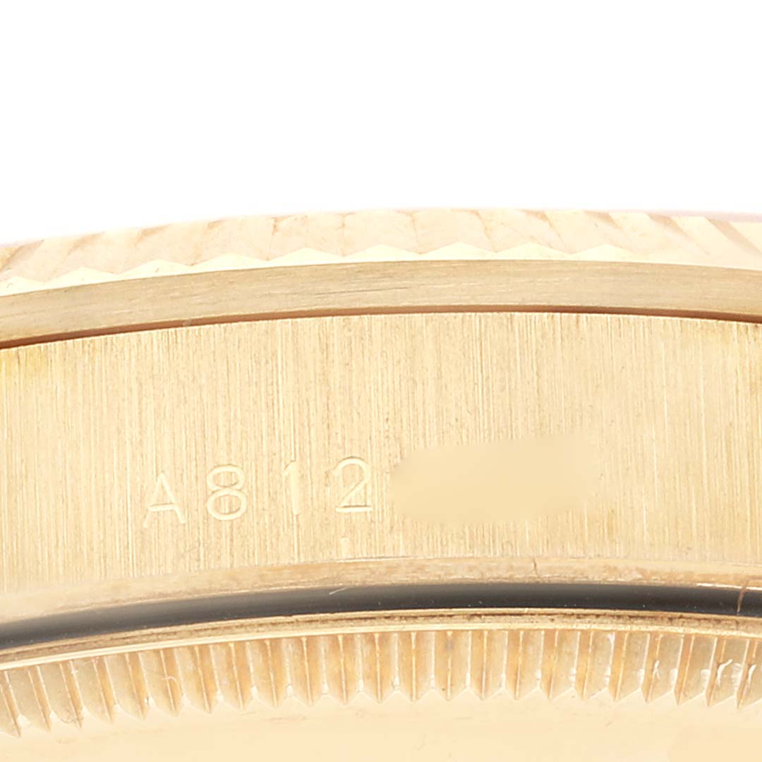 This close-up image shows part of the case and the serial number of the Rolex President 78278 Women's Yellow Gold Champagne Dial 78278 Women's Yellow Gold Champagne Dial model watch.