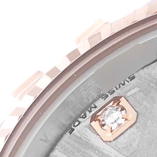 This close-up of a Rolex Datejust 179171 Women's Steel and Gold (two tone) Silver Dial 179171 Women's Steel and Gold (two tone) Silver Dial watch shows part of the bezel, case, and diamond hour marker on the dial.