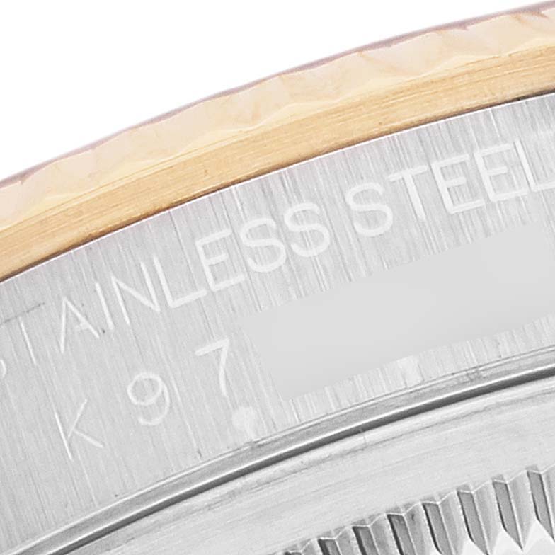 This image shows a close-up of the side inscription and part of the bezel of a Rolex Datejust 16233 Men's Steel and Gold (two tone) Black Dial 16233 Men's Steel and Gold (two tone) Black Dial watch.